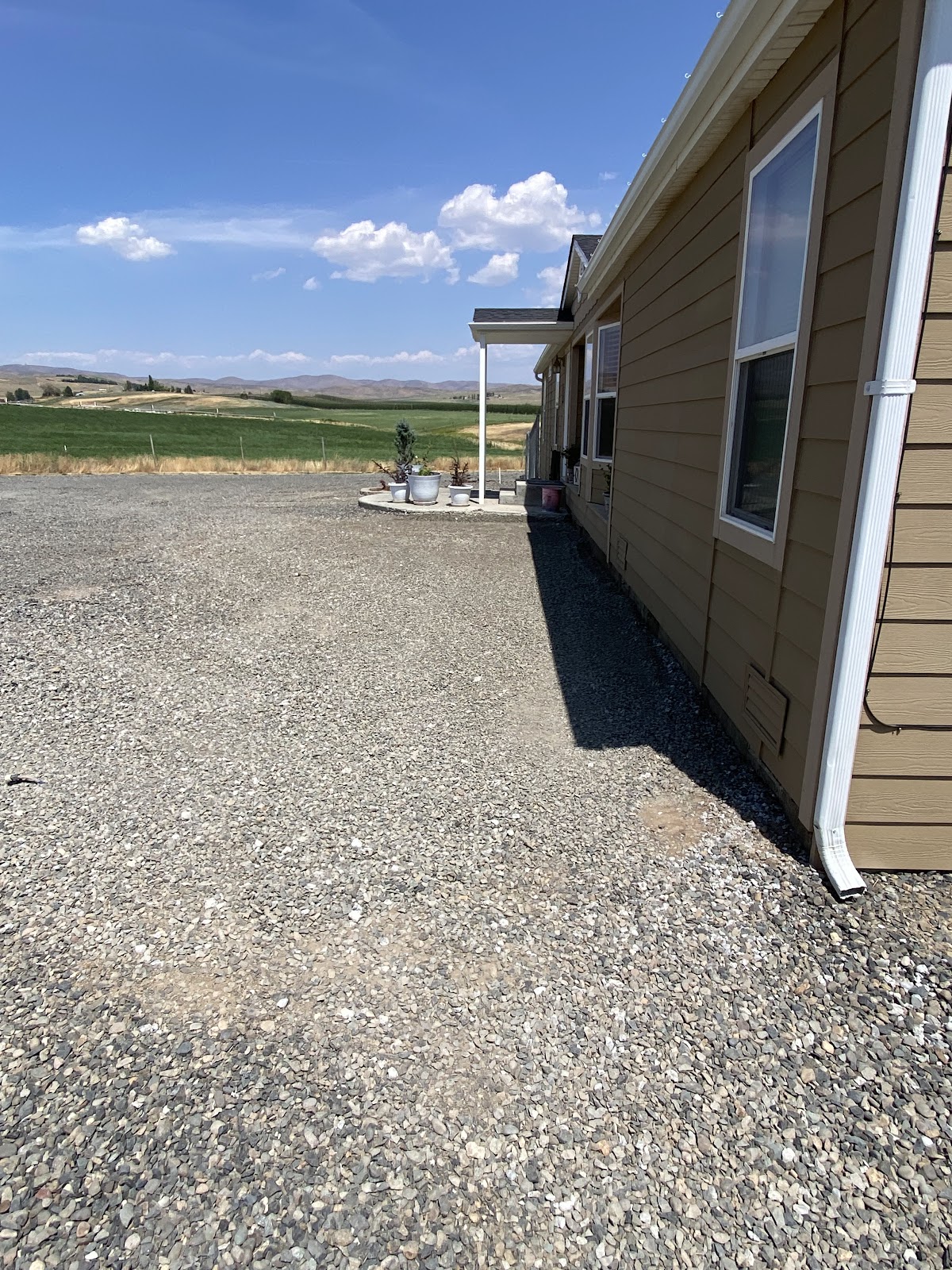 Fresh gravel delivered and spread alongside a home